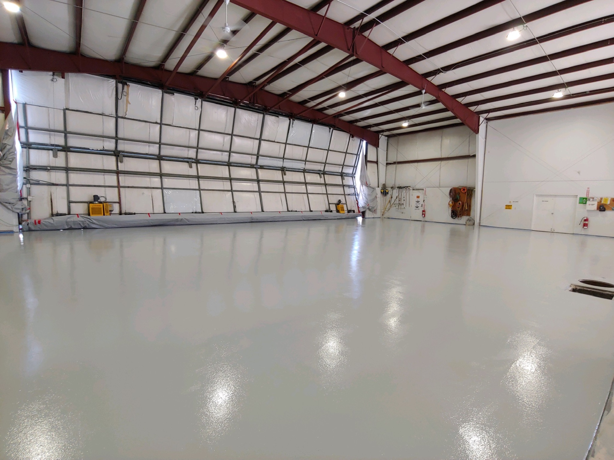 Full view of aircraft hangar floor with light gray professional coating - Sparks Coatings