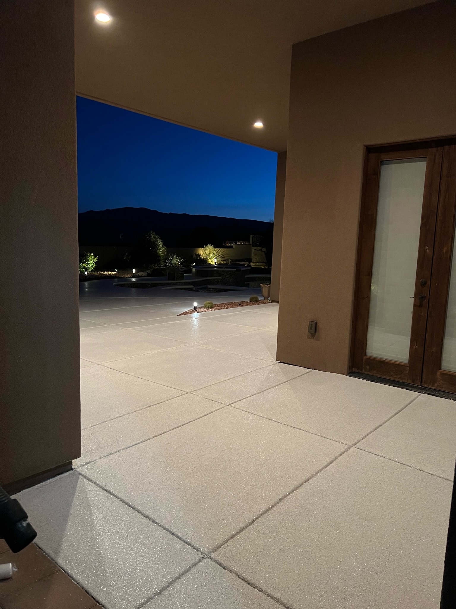 Premium outdoor living space with coated patio floor at twilight by Sparks Coatings