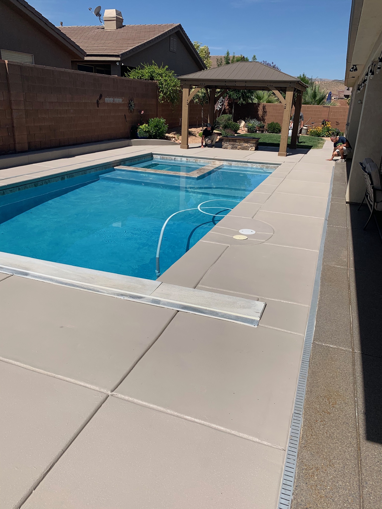 Pool deck with light tan professional coating by Sparks Coatings