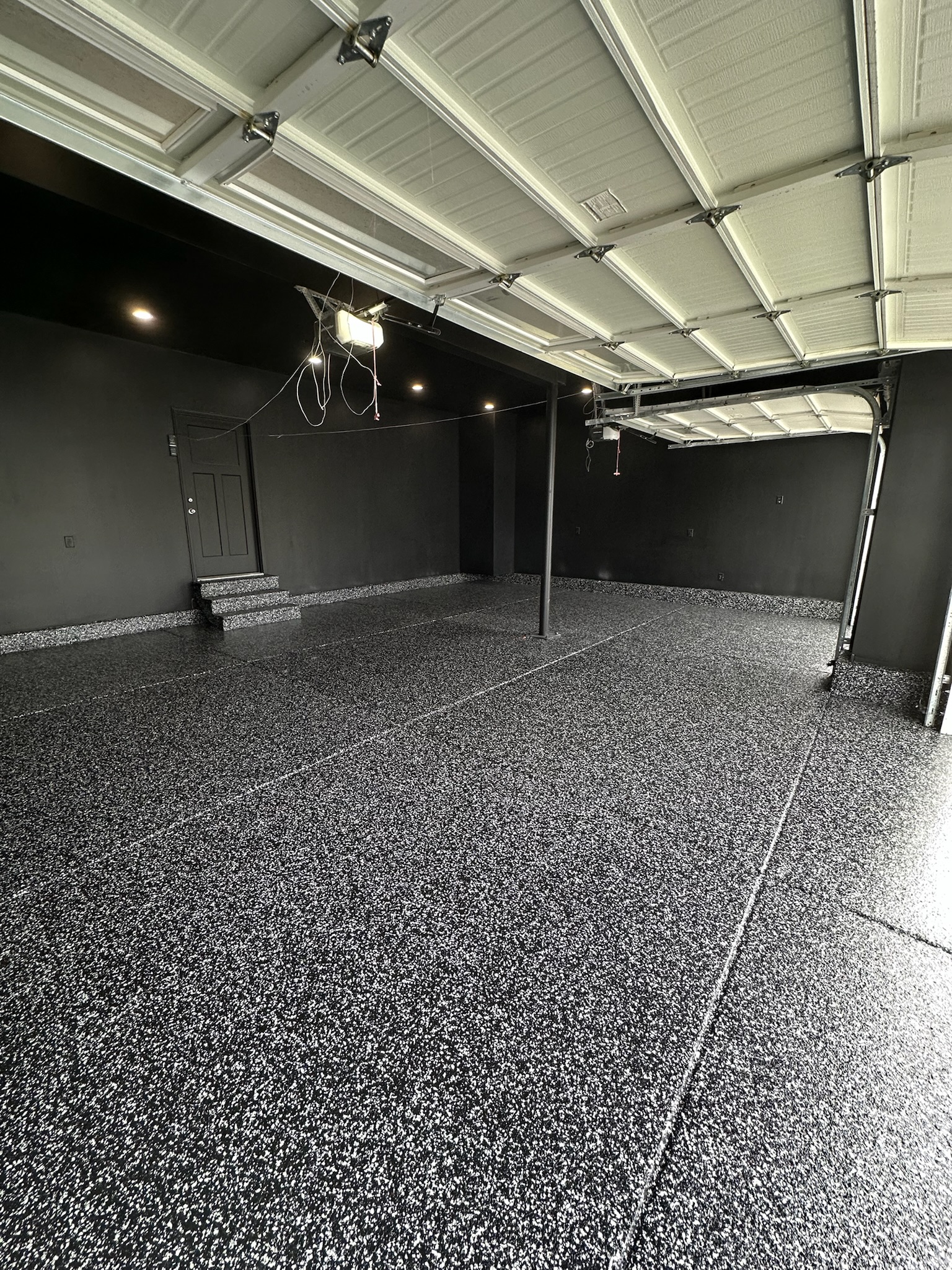 Black speckle floor coating in dramatic luxury garage Utah