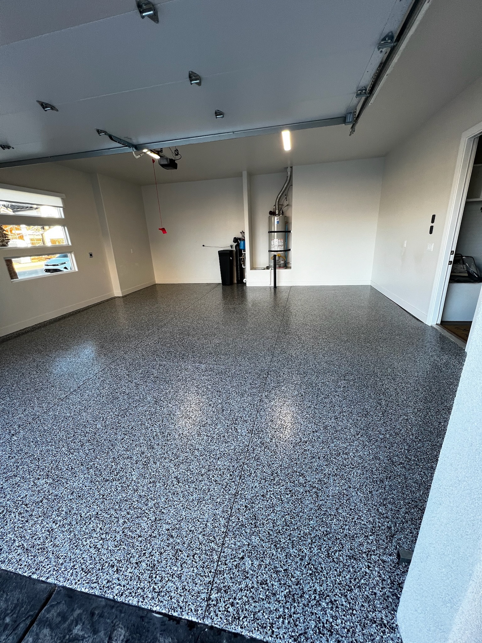 Two car garage with charcoal full-broadcast floor coating - Sparks Coatings