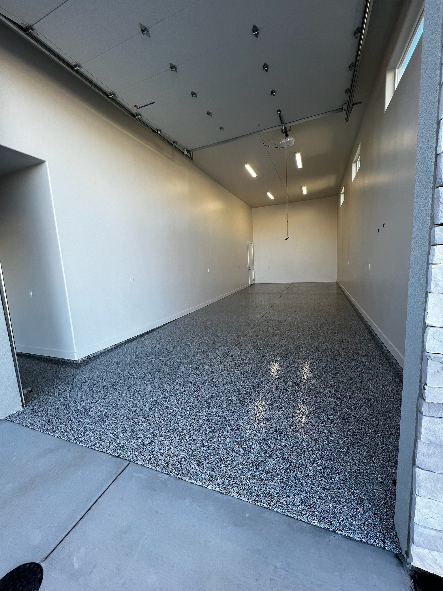 Single car garage with gray professional floor coating - Sparks Coatings Utah