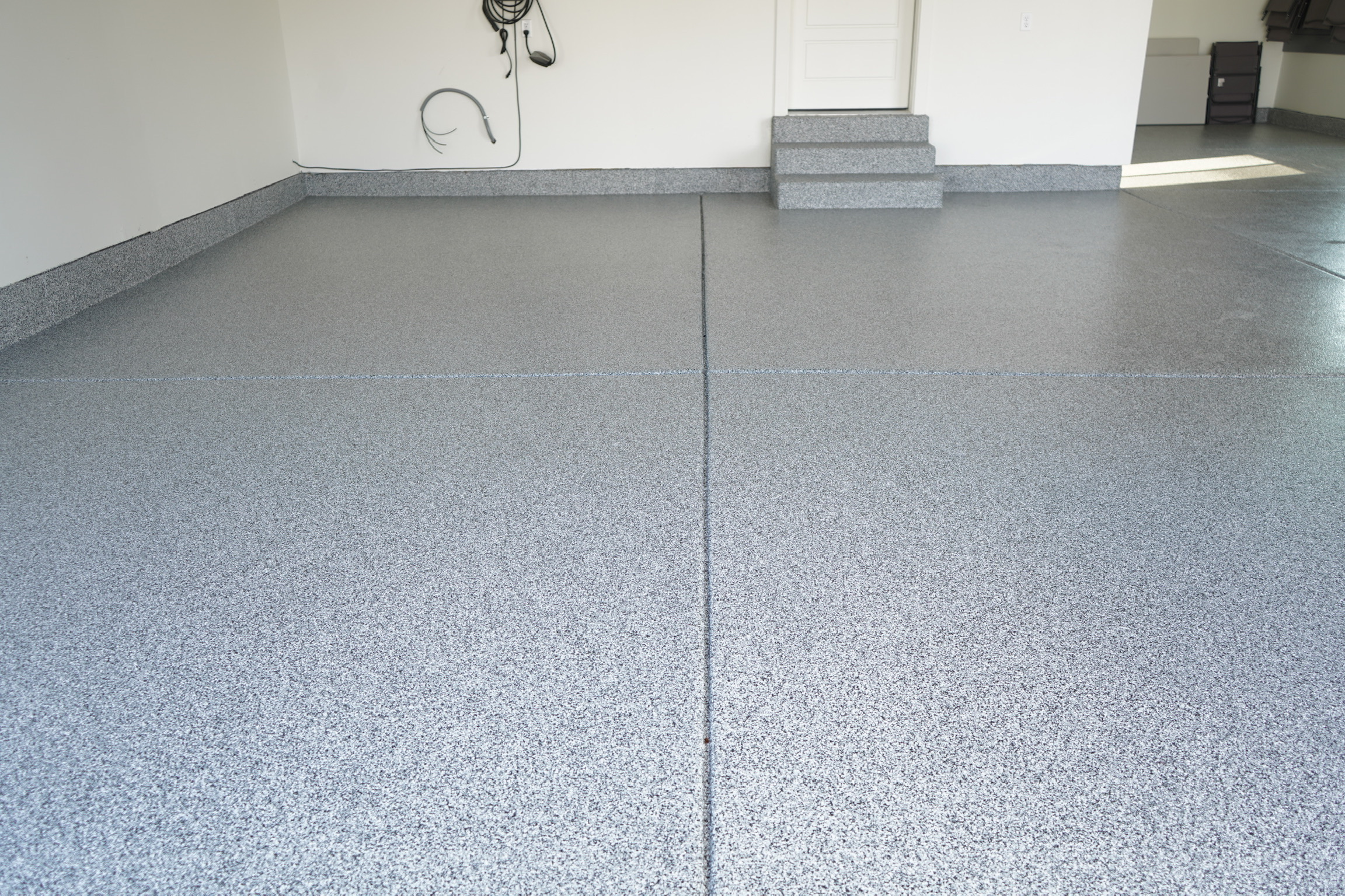 Large garage floor with gray full-broadcast flake coating - Sparks Coatings